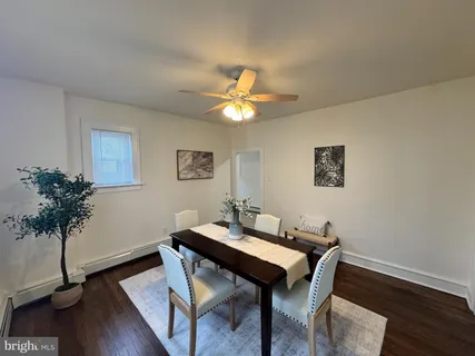 a view of a workspace with furniture and wooden floor