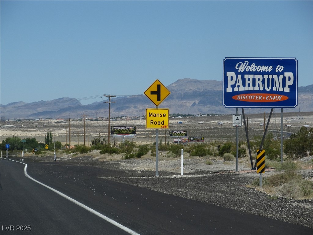 View of asphalt road with traffic signs and a mountain view