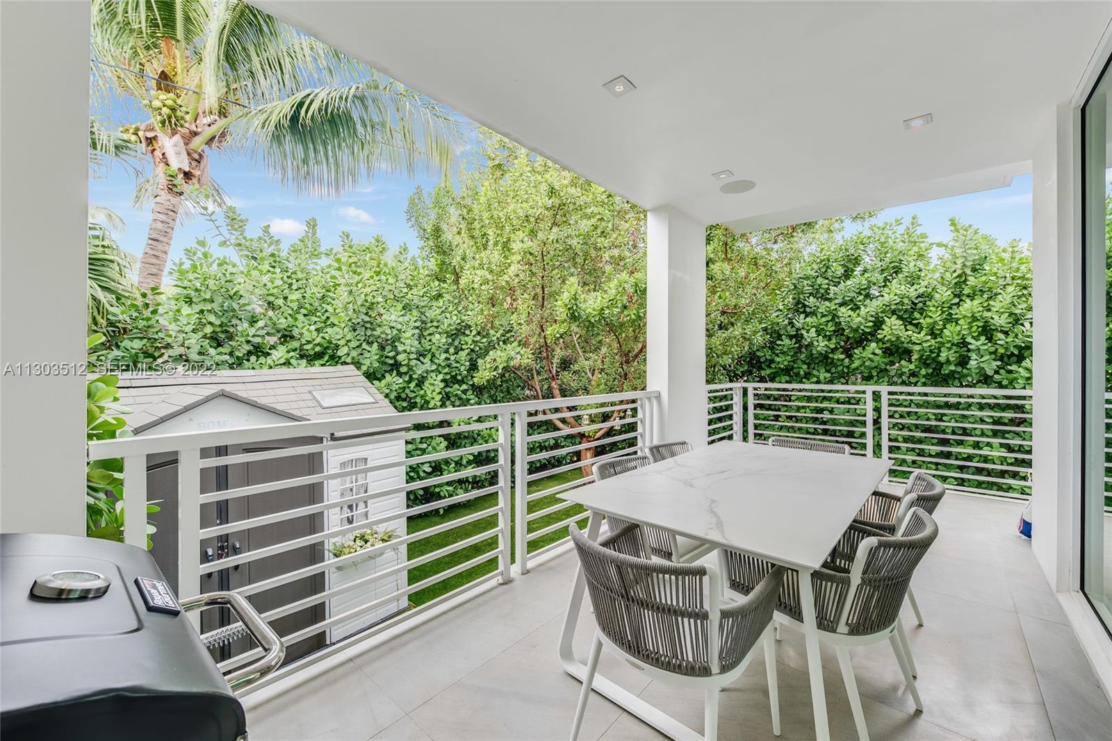 330 Fernwood Road, Unit 1 Key Biscayne, FL 33149 - Photo 13 of 29 a view of a chairs and table in the patio