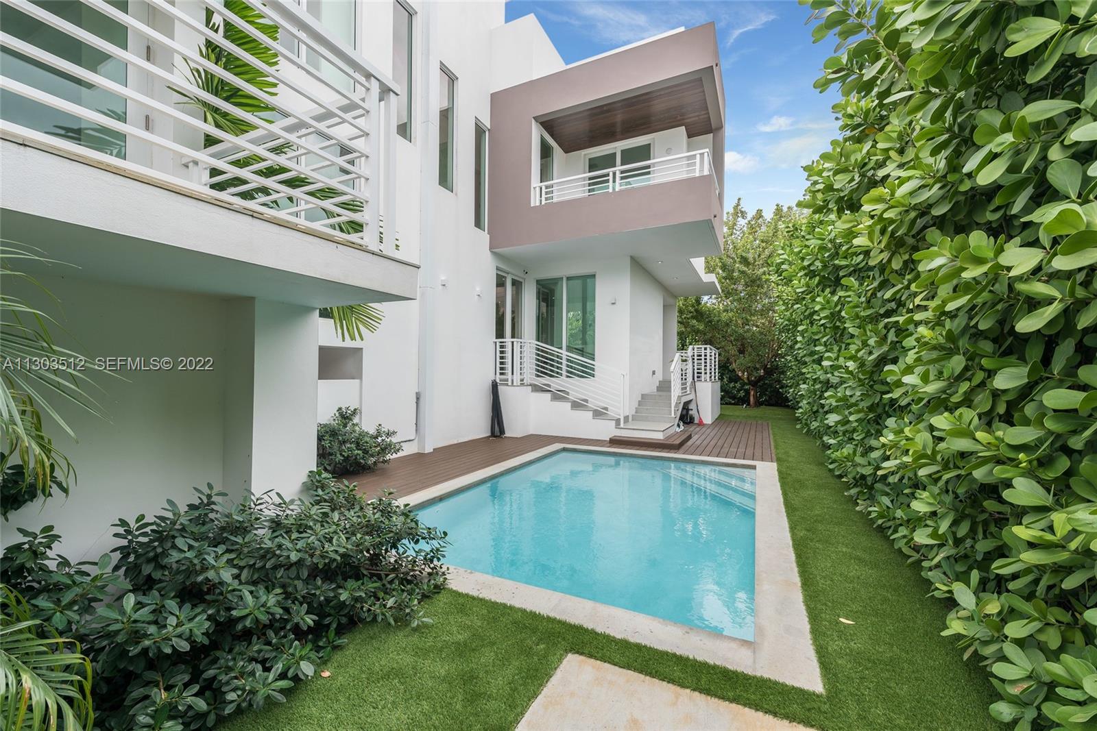 330 Fernwood Road, Unit 1 Key Biscayne, FL 33149 - Photo 16 of 29 a view of a house with a yard potted plants