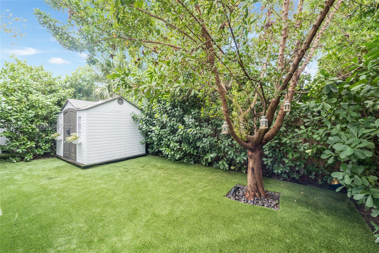 330 Fernwood Road, Unit 1 Key Biscayne, FL 33149 - Photo 18 of 29 a view of a backyard with a tree