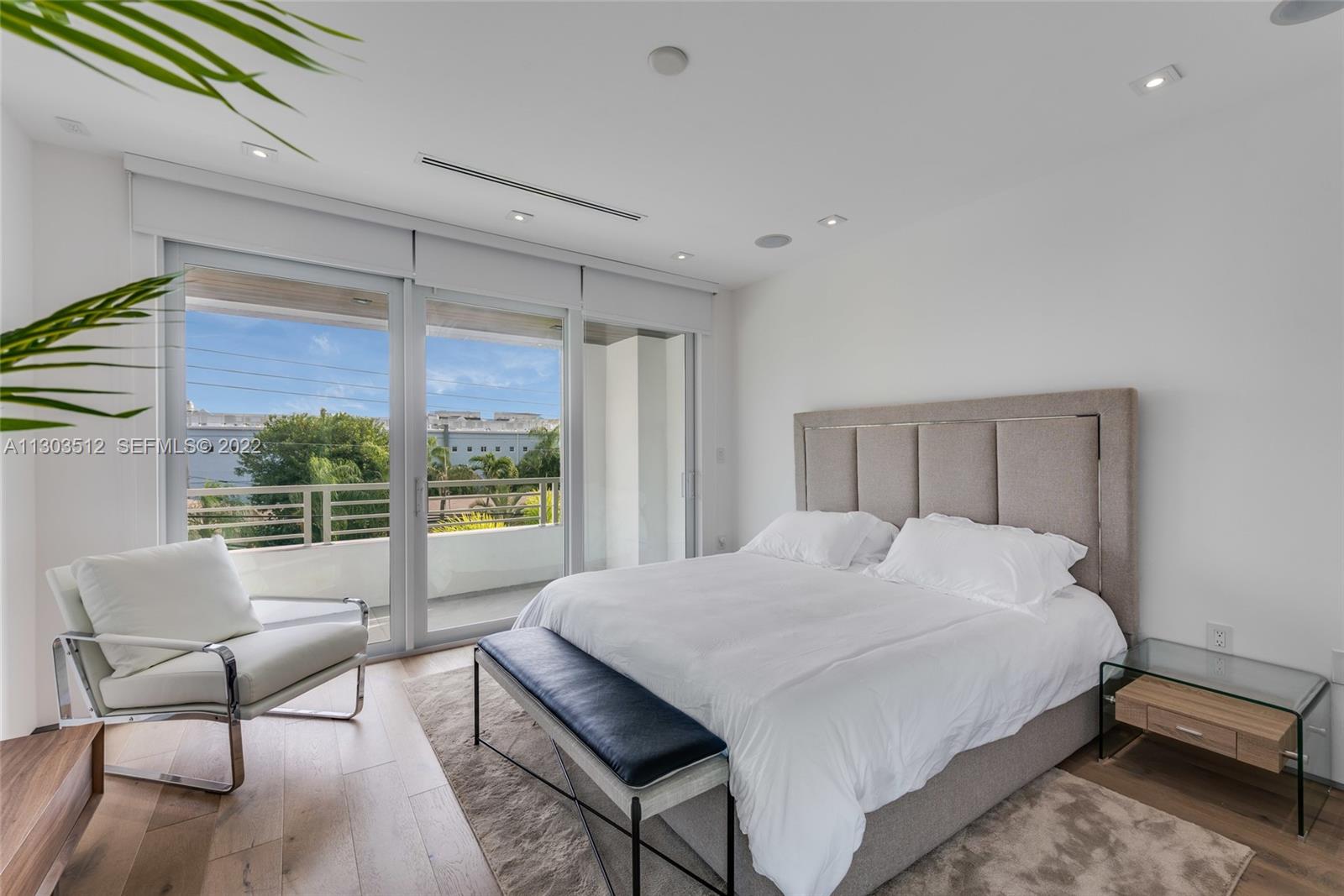 330 Fernwood Road, Unit 1 Key Biscayne, FL 33149 - Photo 19 of 29 a bedroom with a bed and a large window