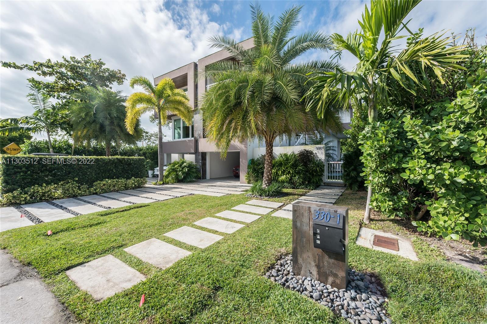 330 Fernwood Road, Unit 1 Key Biscayne, FL 33149 - Photo 2 of 29 a patio with table and chairs plants and palm trees