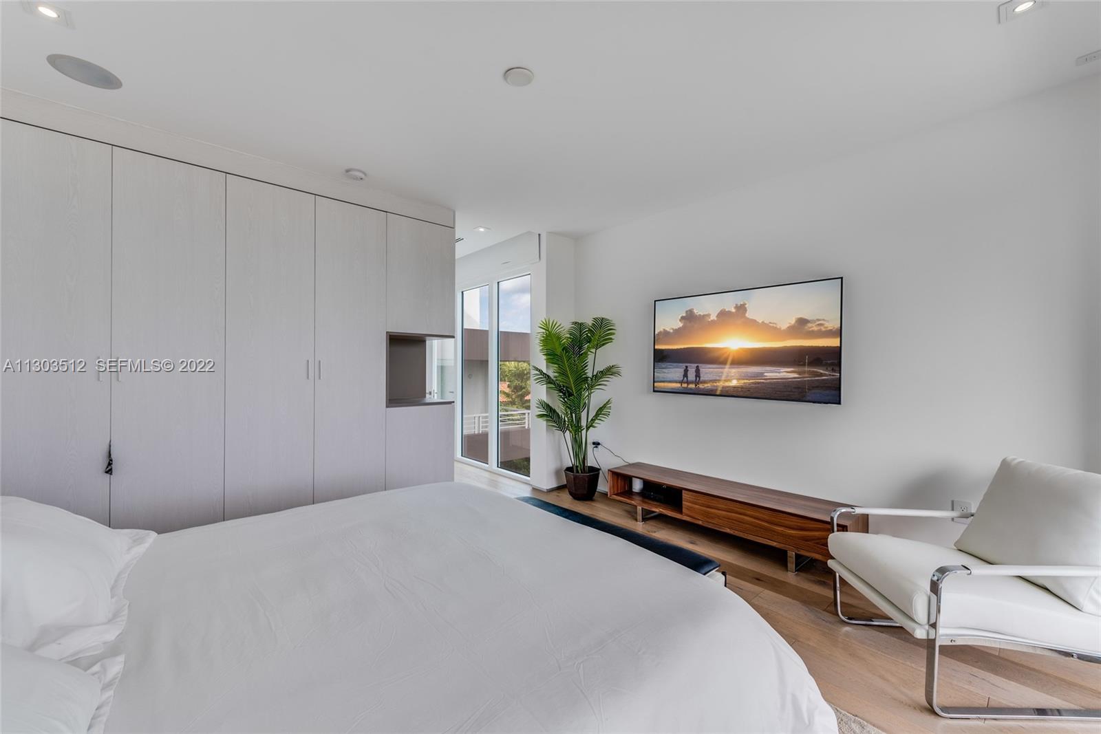 330 Fernwood Road, Unit 1 Key Biscayne, FL 33149 - Photo 21 of 29 a bedroom with bed and a potted plant