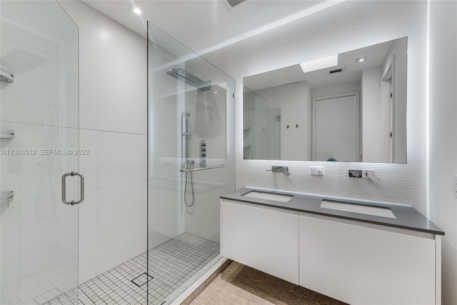 330 Fernwood Road, Unit 1 Key Biscayne, FL 33149 - Photo 22 of 29 a bathroom with a shower sink and mirror