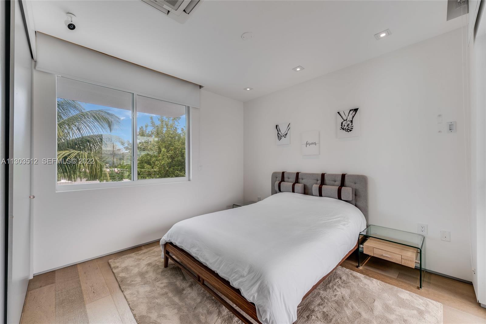 330 Fernwood Road, Unit 1 Key Biscayne, FL 33149 - Photo 23 of 29 a bedroom with a bed a window and painting on the wall