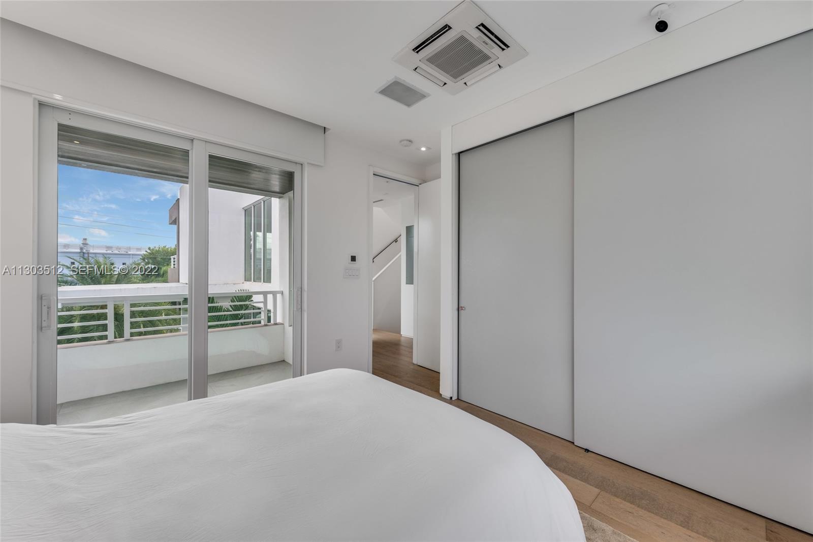 330 Fernwood Road, Unit 1 Key Biscayne, FL 33149 - Photo 24 of 29 a view of a bedroom with wooden floor