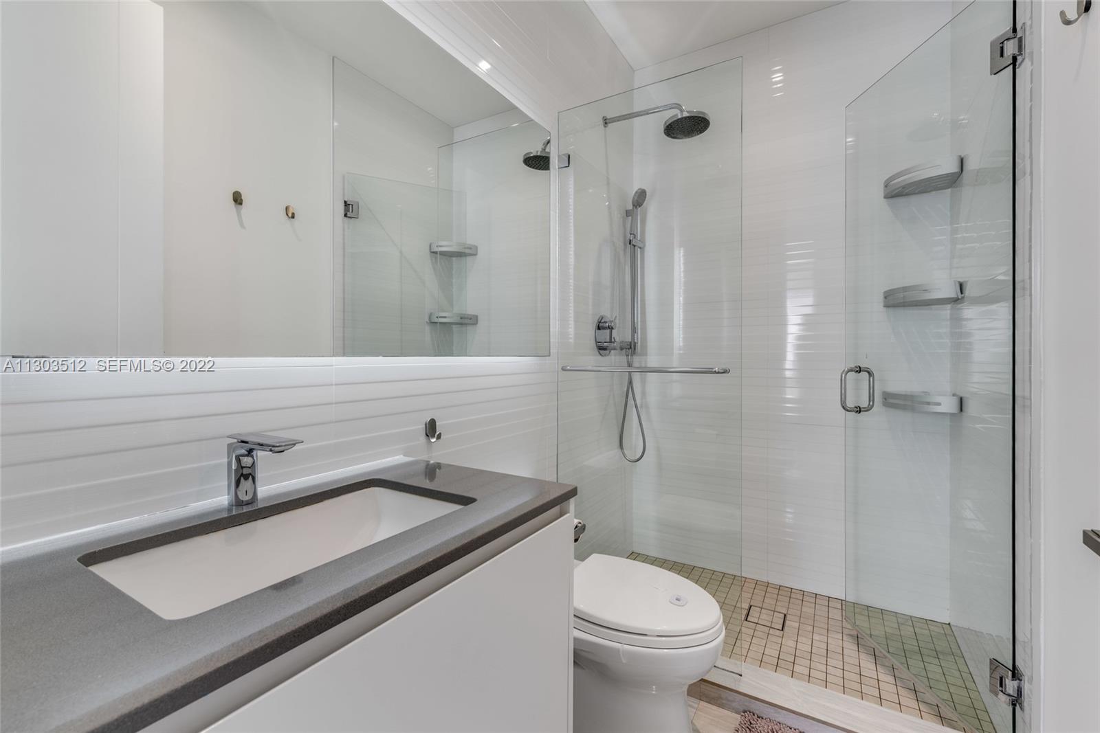 330 Fernwood Road, Unit 1 Key Biscayne, FL 33149 - Photo 26 of 29 a bathroom with a sink a toilet and shower