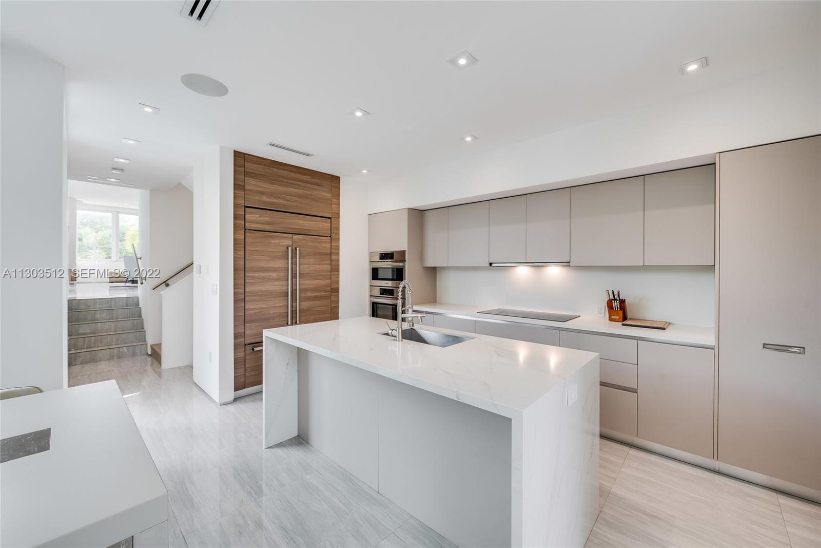 330 Fernwood Road, Unit 1 Key Biscayne, FL 33149 - Photo 7 of 29 a kitchen with kitchen island a sink stove and refrigerator