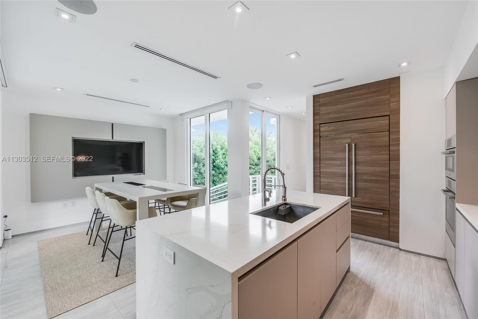 330 Fernwood Road, Unit 1 Key Biscayne, FL 33149 - Photo 9 of 29 a kitchen with stainless steel appliances granite countertop a sink a stove and a refrigerator