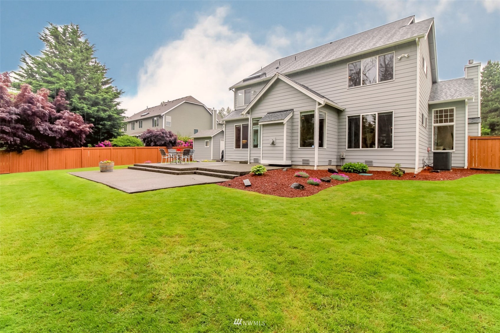 18910 3rd Street East Lake Tapps, WA 98391 - Photo 9 of 18 a front view of house with yard and seating area