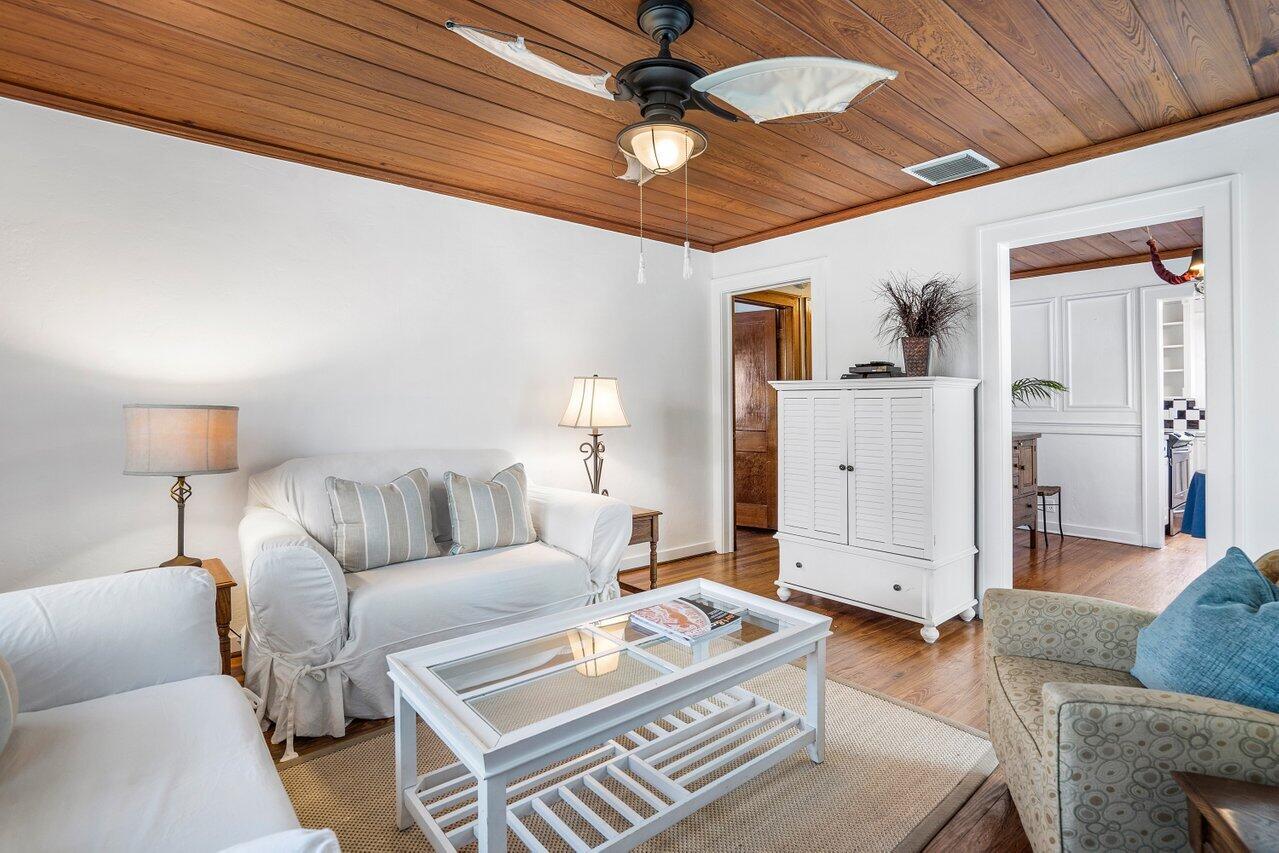 102 Southeast 7th Avenue, Unit VILLA 2 Delray Beach, FL 33483 - Photo 11 of 28 a living room with furniture and a chandelier