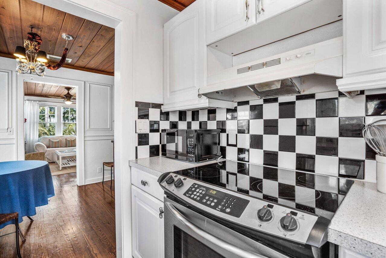 102 Southeast 7th Avenue, Unit VILLA 2 Delray Beach, FL 33483 - Photo 14 of 28 a kitchen with a stove a sink and a refrigerator