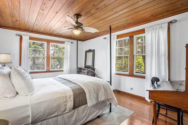 a bedroom with a large bed and a large window