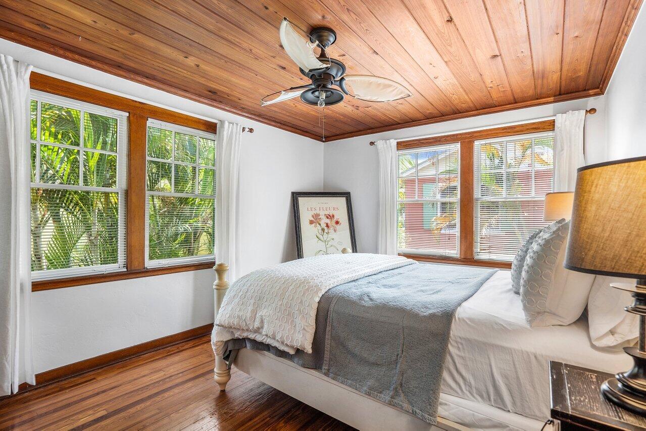 102 Southeast 7th Avenue, Unit VILLA 2 Delray Beach, FL 33483 - Photo 17 of 28 a bedroom with a bed and wooden floor