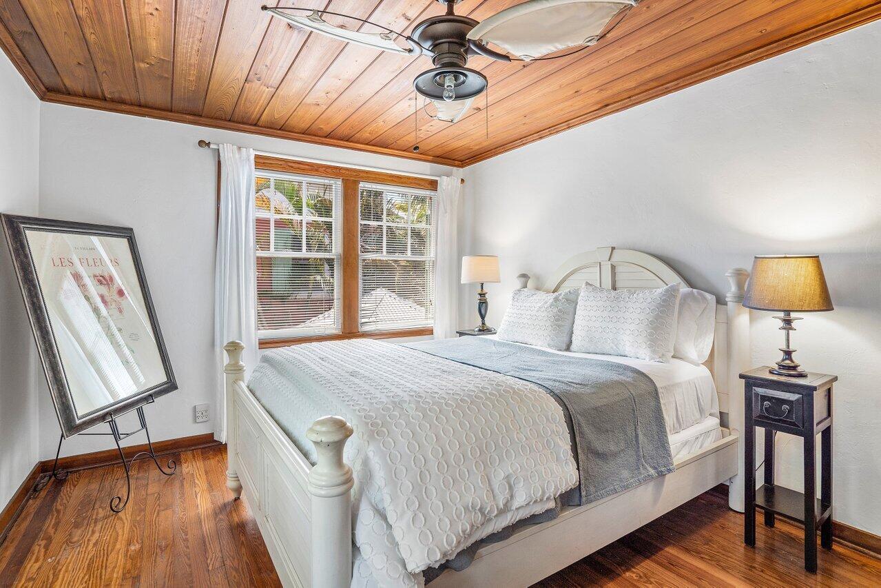 102 Southeast 7th Avenue, Unit VILLA 2 Delray Beach, FL 33483 - Photo 18 of 28 a bedroom with a bed and wooden floor