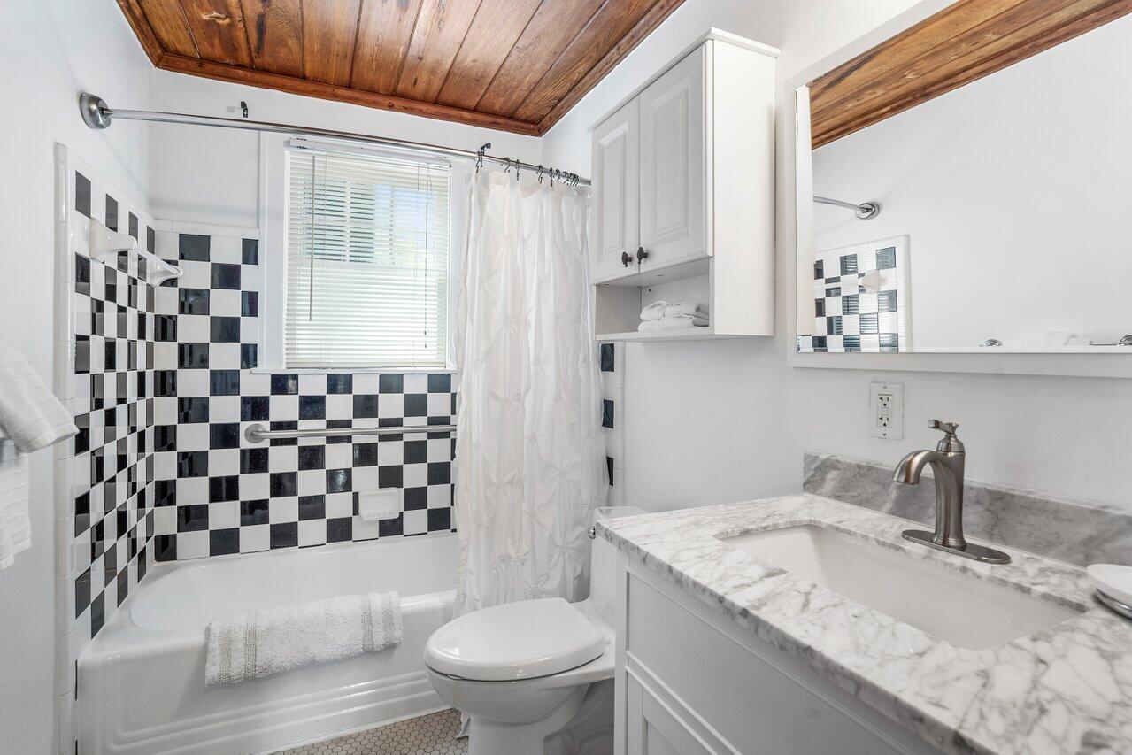 102 Southeast 7th Avenue, Unit VILLA 2 Delray Beach, FL 33483 - Photo 19 of 28 a bathroom with a granite countertop sink toilet and shower