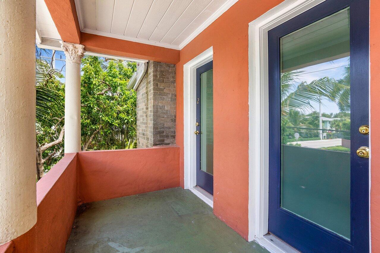 102 Southeast 7th Avenue, Unit VILLA 2 Delray Beach, FL 33483 - Photo 5 of 28 a view of an empty room with large windows and a bed