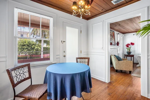 a view of a dining room with furniture wooden floor and a chandelier