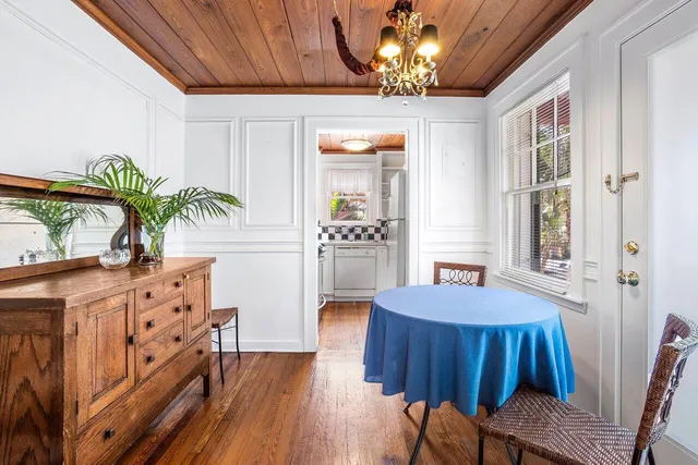 a large dining space with furniture window and wooden floor