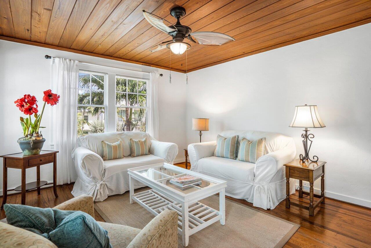 102 Southeast 7th Avenue, Unit VILLA 2 Delray Beach, FL 33483 - Photo 9 of 28 a living room with furniture a chandelier and a window