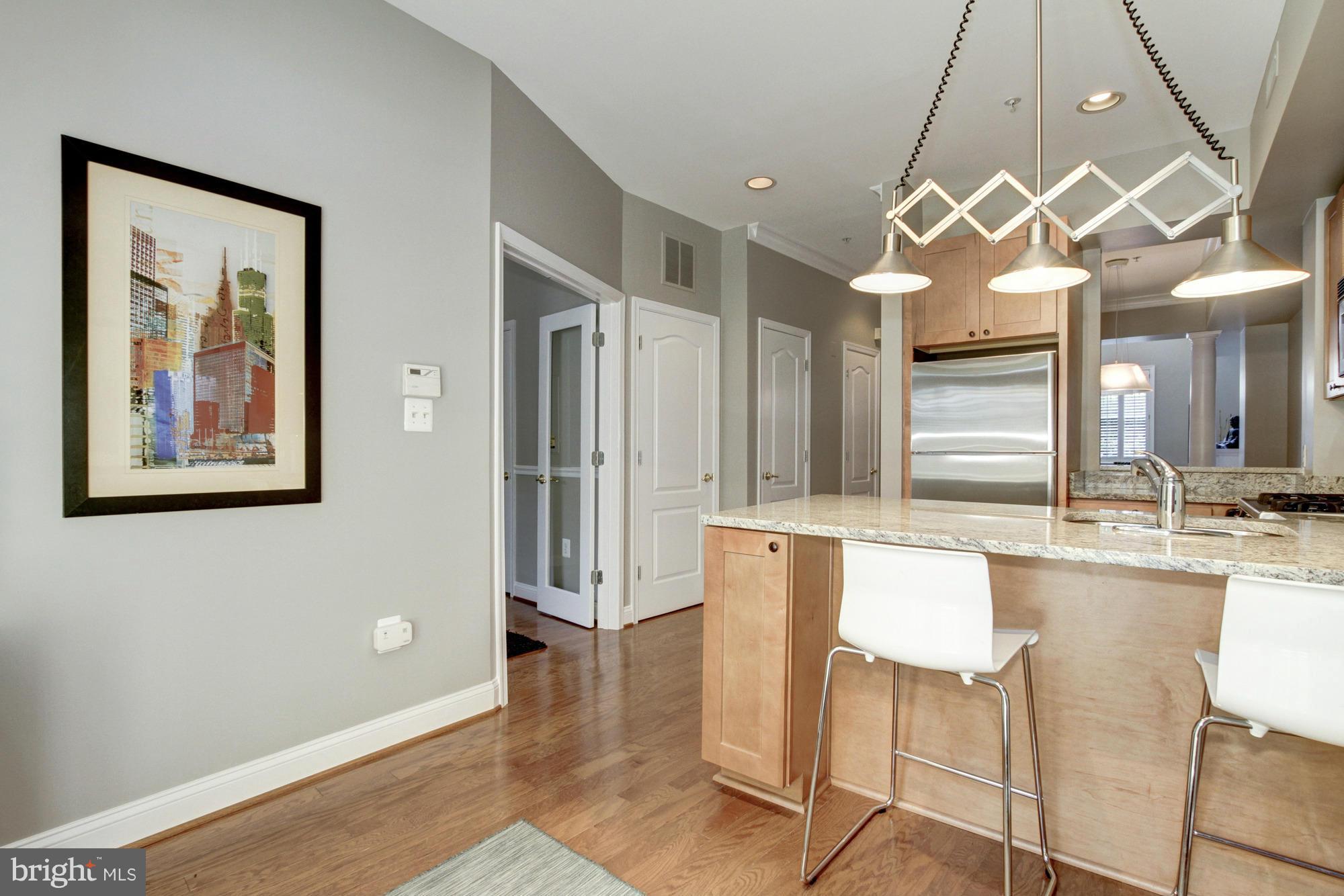 27 Logan Circle Northwest, Unit 1 Washington, DC 20005 - Photo 13 of 30 a large kitchen with a large window cabinets and stainless steel appliances