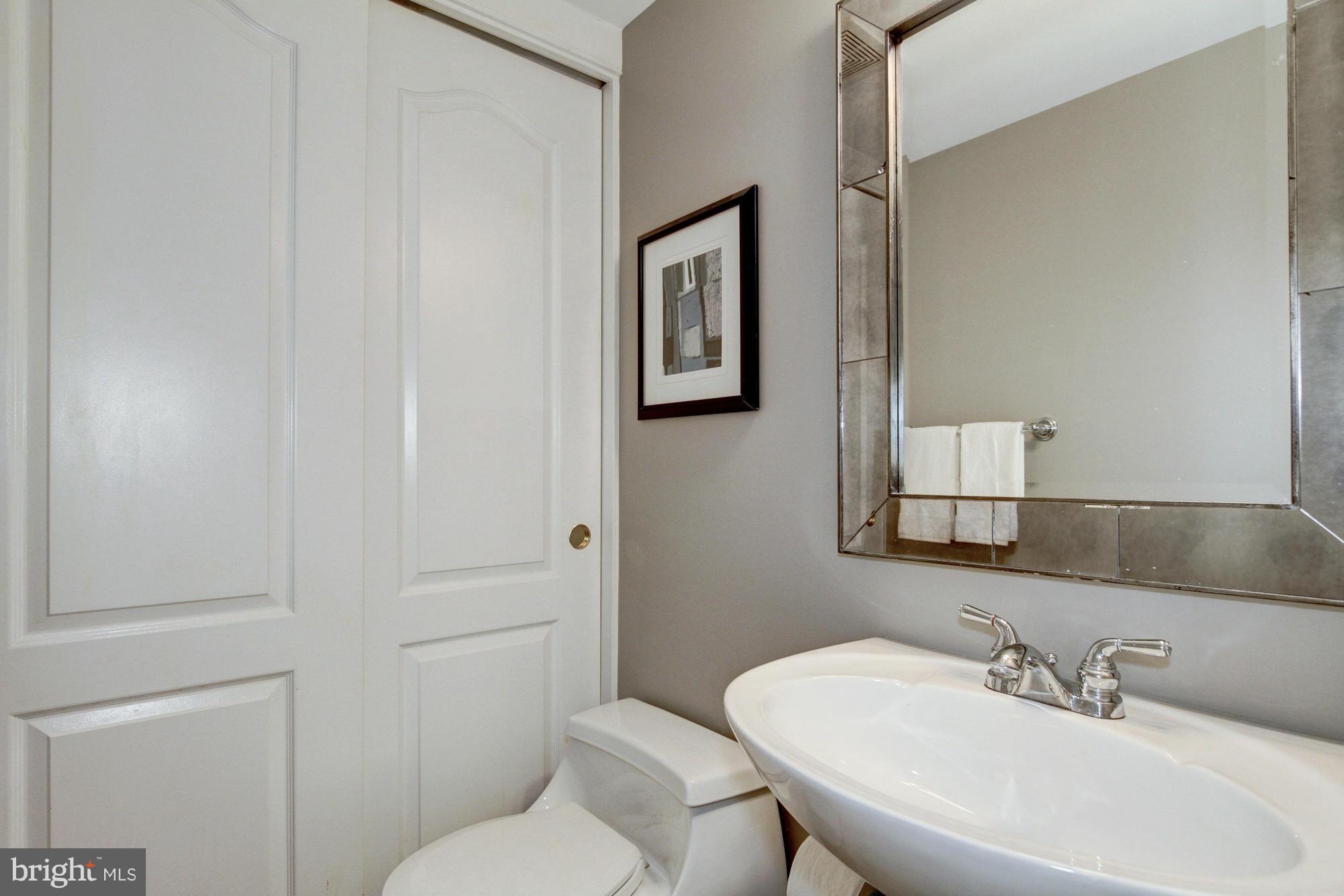 27 Logan Circle Northwest, Unit 1 Washington, DC 20005 - Photo 14 of 30 a bathroom with a toilet a sink and mirror