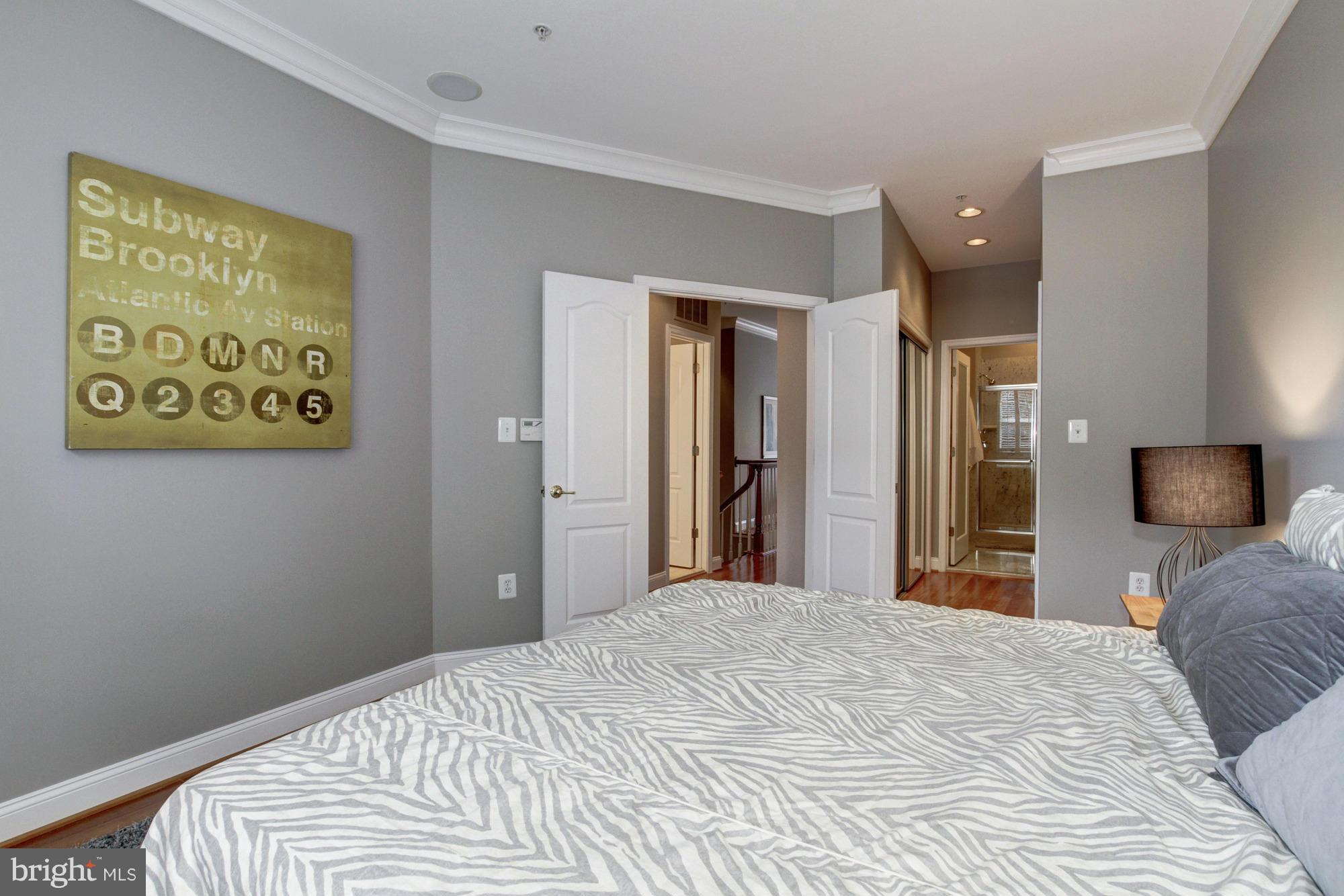 27 Logan Circle Northwest, Unit 1 Washington, DC 20005 - Photo 18 of 30 a bedroom with a bed and a flat screen tv