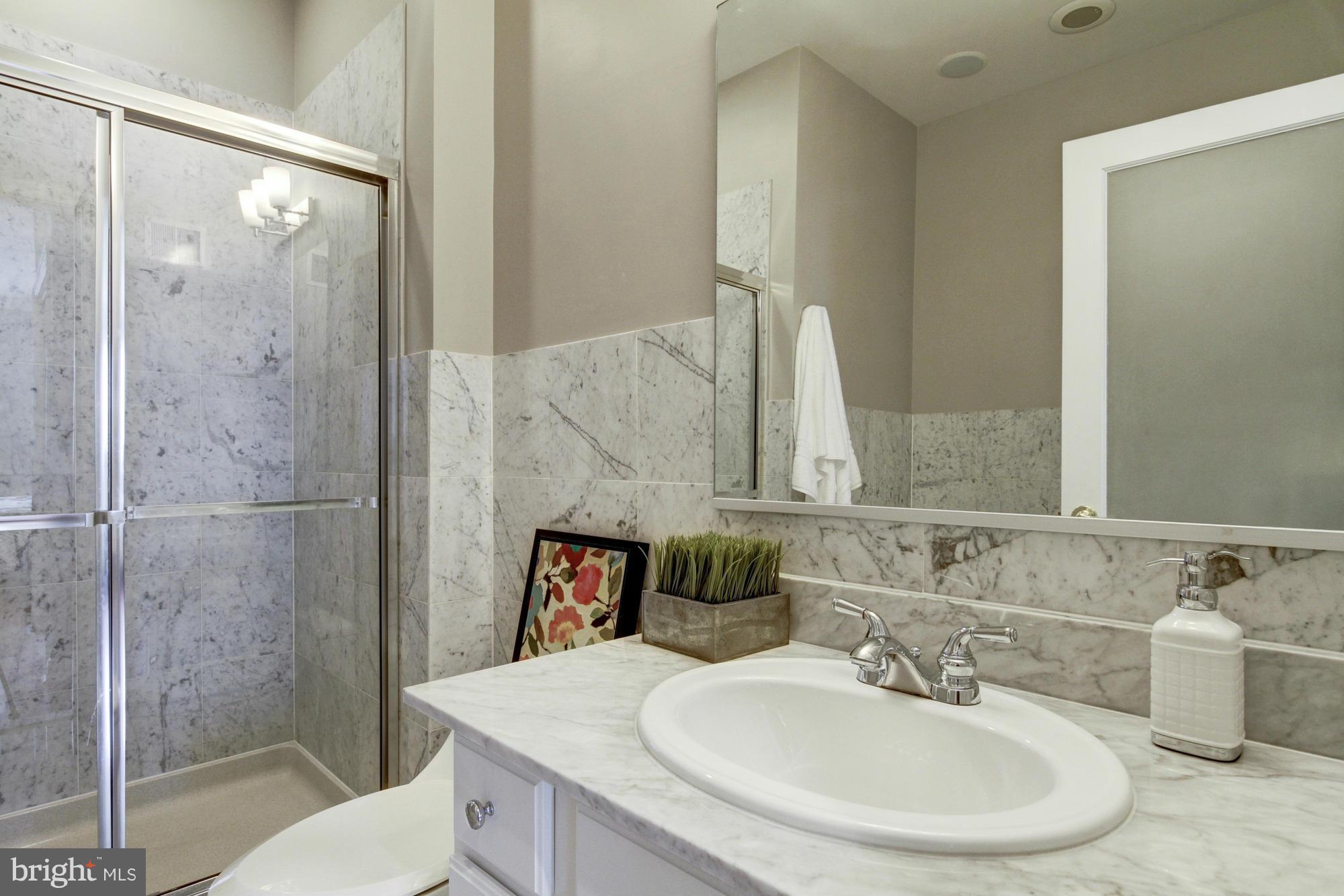 27 Logan Circle Northwest, Unit 1 Washington, DC 20005 - Photo 20 of 30 a bathroom with a sink and a mirror