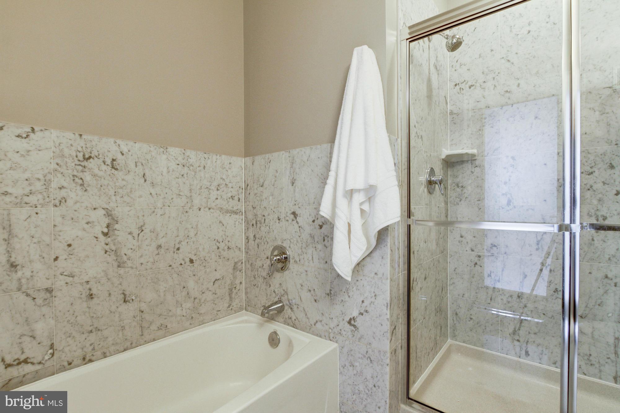 27 Logan Circle Northwest, Unit 1 Washington, DC 20005 - Photo 21 of 30 a bathroom with a bathtub and a shower