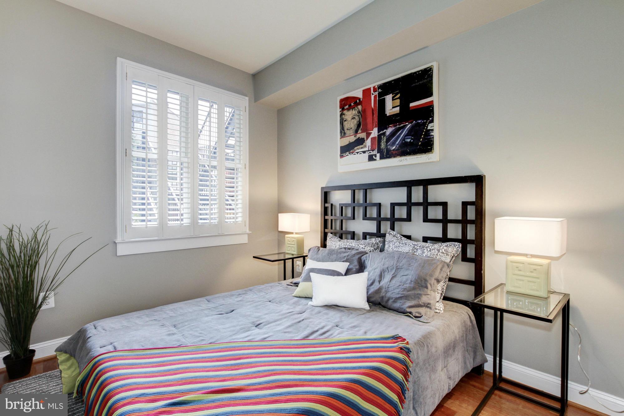 27 Logan Circle Northwest, Unit 1 Washington, DC 20005 - Photo 22 of 30 a bedroom with a bed and a painting on the wall
