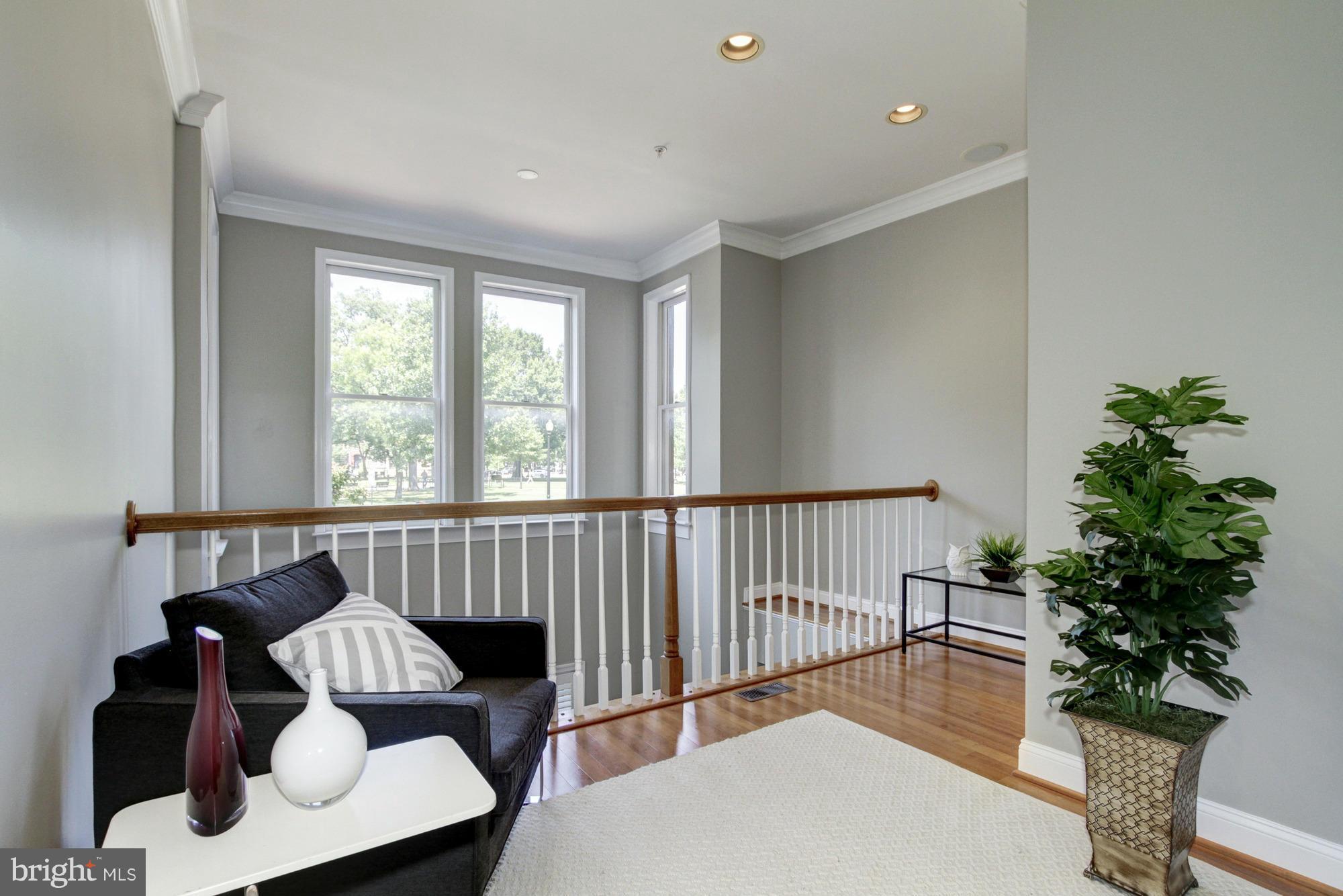 27 Logan Circle Northwest, Unit 1 Washington, DC 20005 - Photo 26 of 30 a living room with furniture and a potted plant