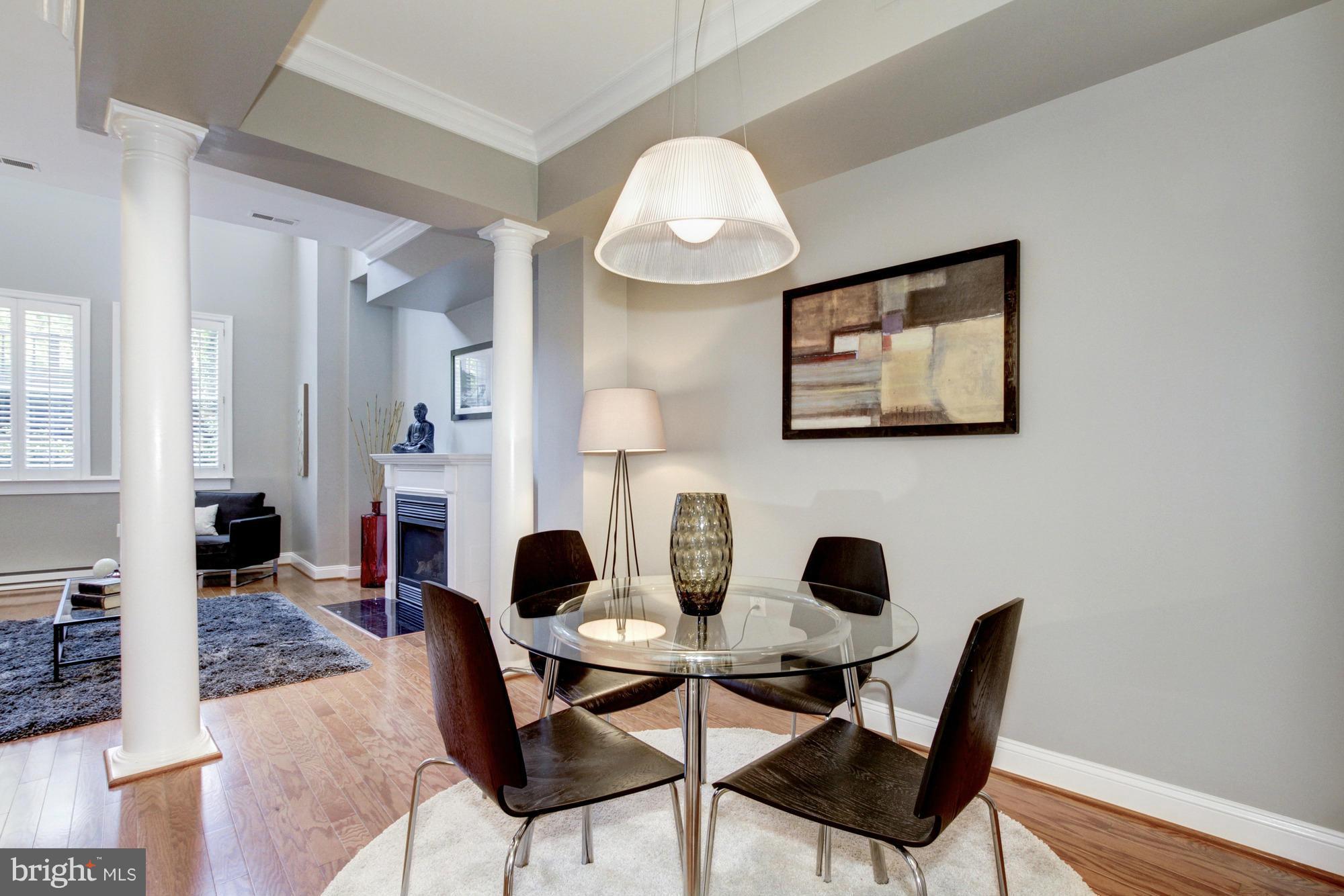 27 Logan Circle Northwest, Unit 1 Washington, DC 20005 - Photo 5 of 30 a view of a dining room with furniture and a fireplace