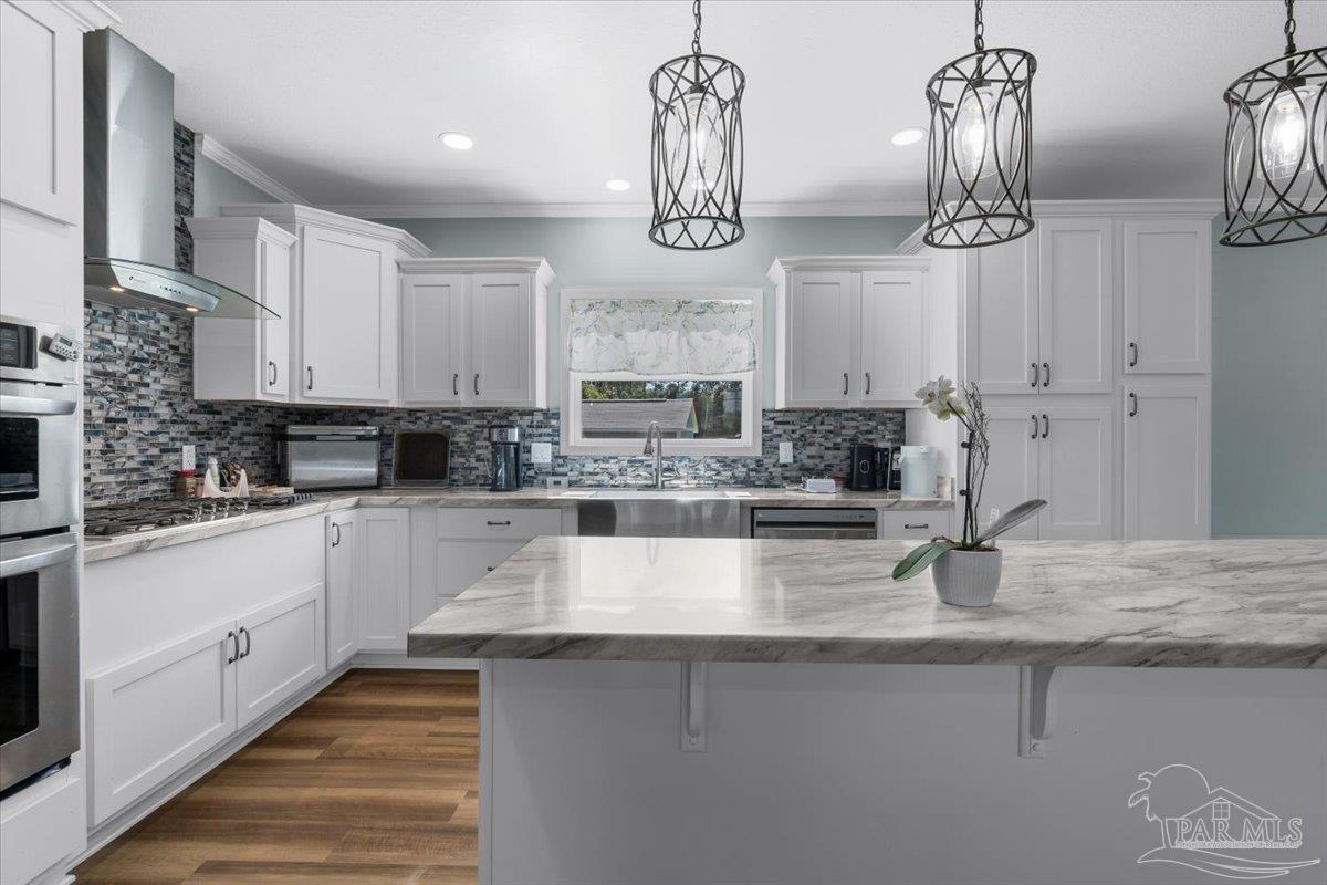 4955 Blue Ribbon Drive Milton, FL 32583 - Photo 2 of 32 a kitchen with stainless steel appliances granite countertop a sink and cabinets