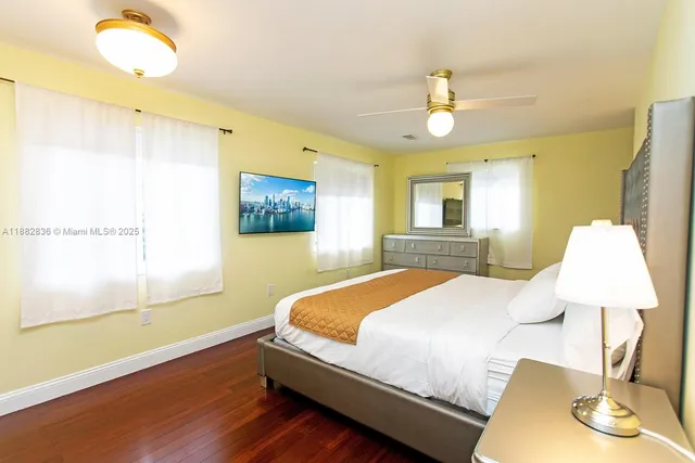 a bedroom with a bed chandelier and a window