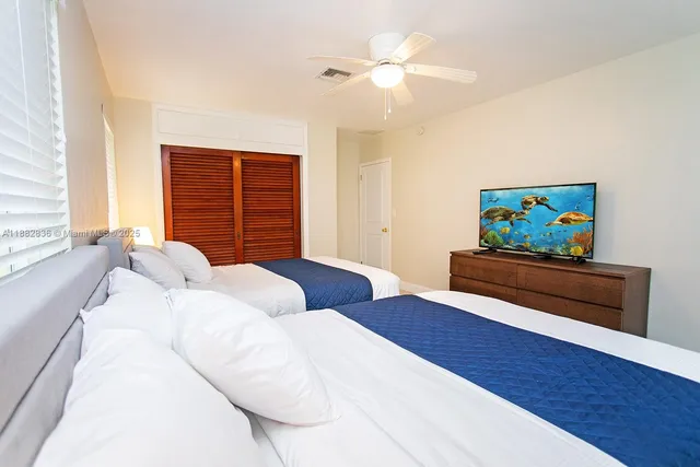 a bedroom with furniture and a window