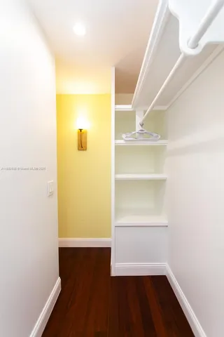 a view of walk in closet with empty room