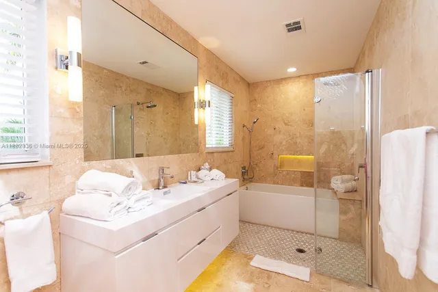 a bathroom with a tub sink and mirror