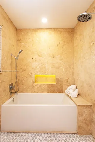 a bathroom with a bathtub and shower