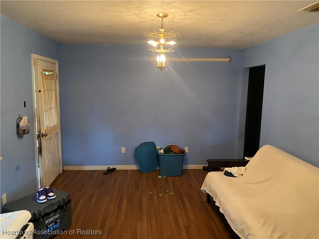 405 S Road Wauchula, FL 33873 - Photo 9 of 14 a bedroom with a bed and wooden floor