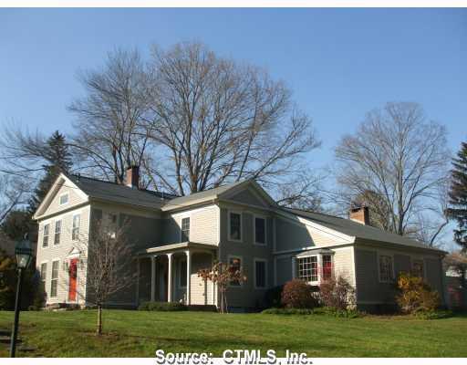 62 West Main Street Chester, CT 06412 - Photo 1 of 1 a front view of a house with a yard and trees