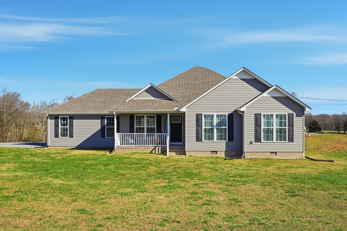 186 L Mitchell Road Flintville, TN 37335 - Photo 1 of 40 a front view of a house with a yard table and chairs
