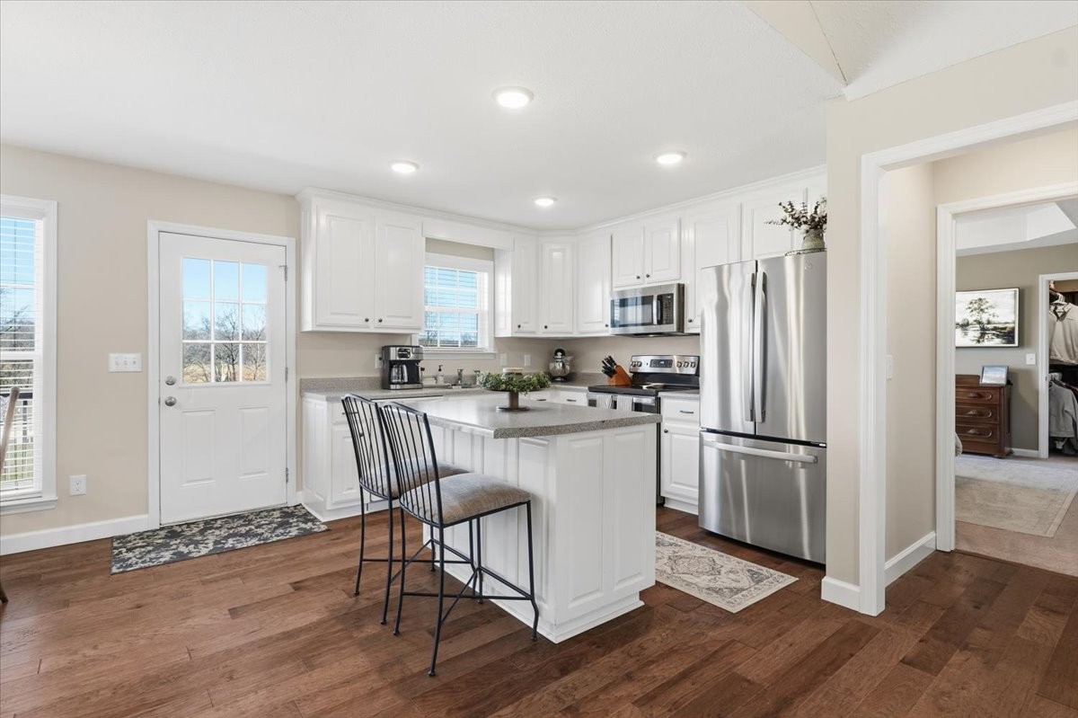 186 L Mitchell Road Flintville, TN 37335 - Photo 11 of 40 a kitchen with kitchen island white cabinets and stainless steel appliances