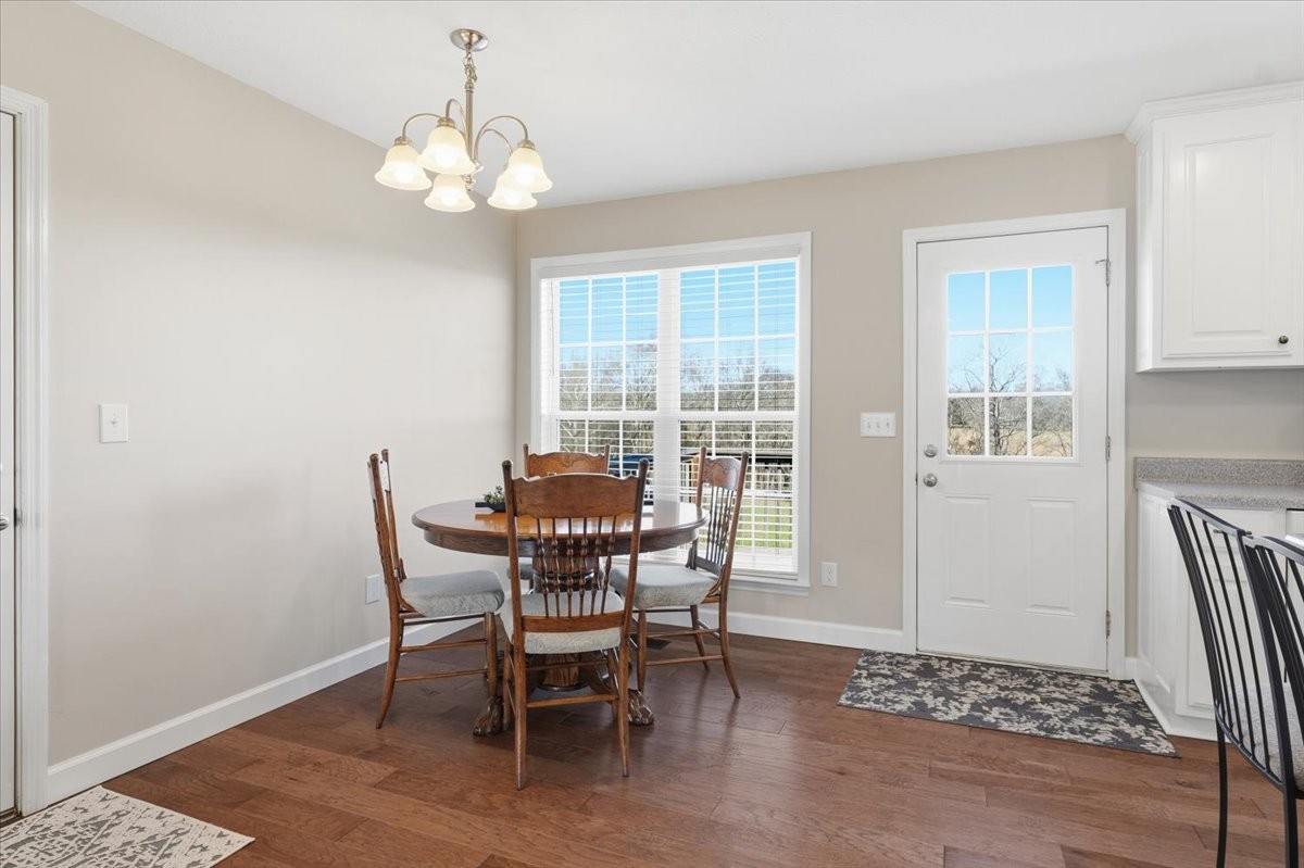186 L Mitchell Road Flintville, TN 37335 - Photo 14 of 40 a dining room with wooden floor and a chandelier