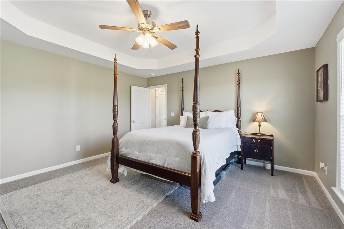 186 L Mitchell Road Flintville, TN 37335 - Photo 17 of 40 a bedroom with a bed and a chandelier