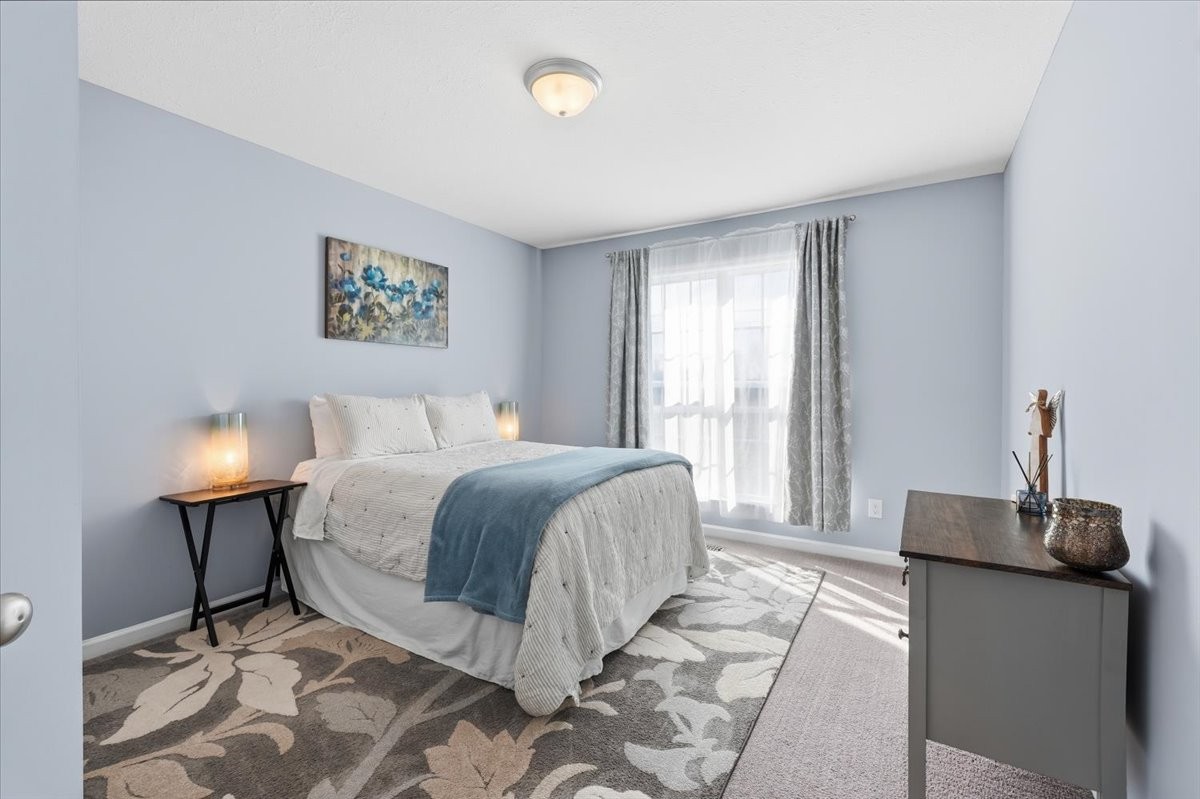 186 L Mitchell Road Flintville, TN 37335 - Photo 23 of 40 a bedroom with a bed and a lamp