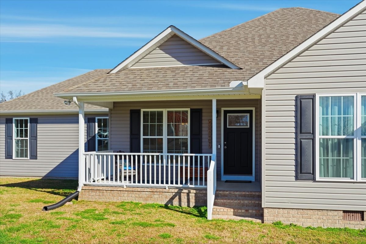 186 L Mitchell Road Flintville, TN 37335 - Photo 5 of 40 a porch with a bench next to a yard
