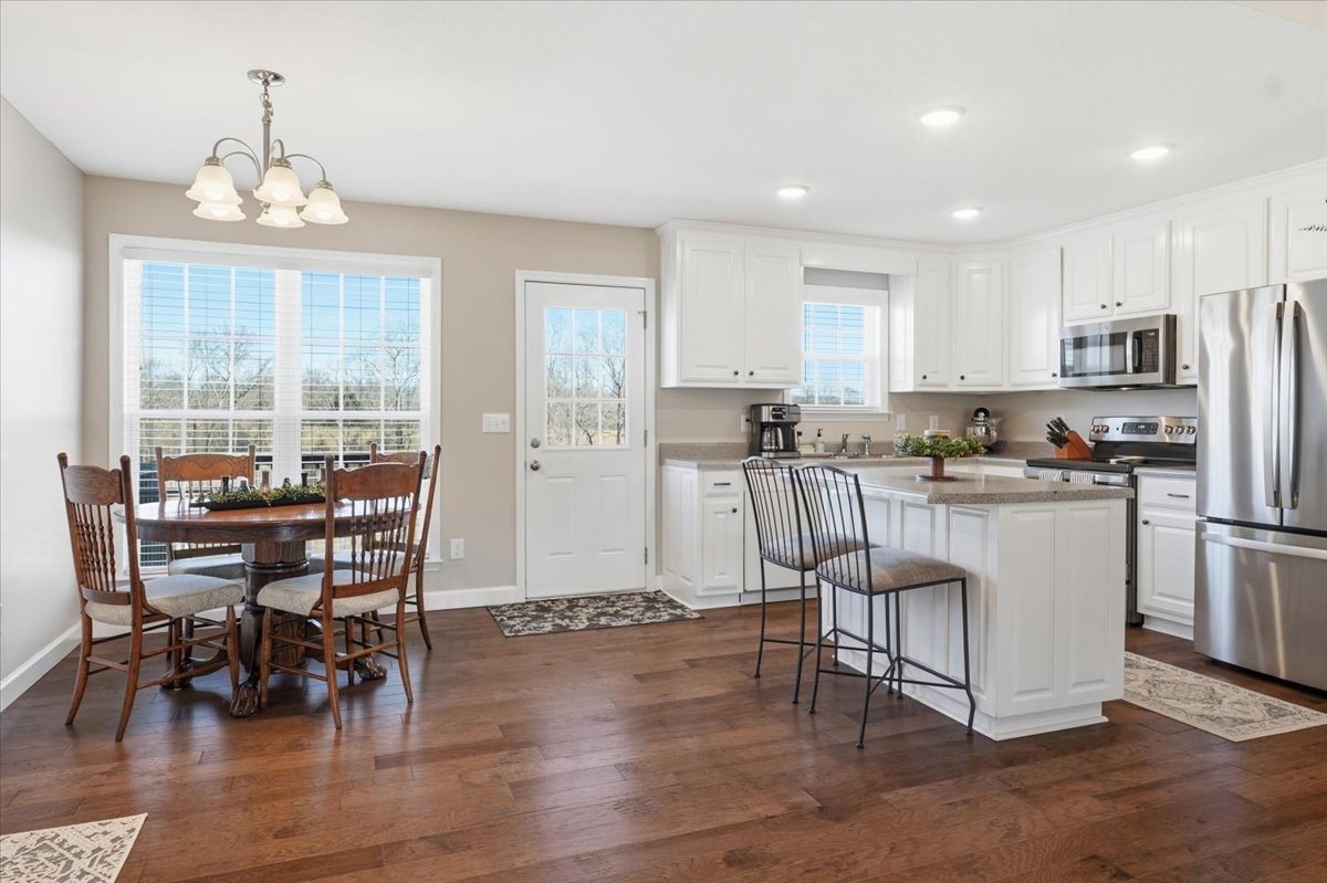 186 L Mitchell Road Flintville, TN 37335 - Photo 10 of 40 a kitchen with stainless steel appliances granite countertop a table chairs refrigerator a sink and dishwasher