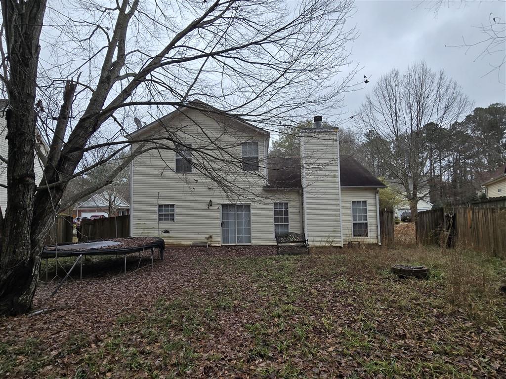 1558 Silver Ridge Drive Southwest Austell, GA 30106 - Photo 2 of 24 a backyard of a house with large trees and brick walls
