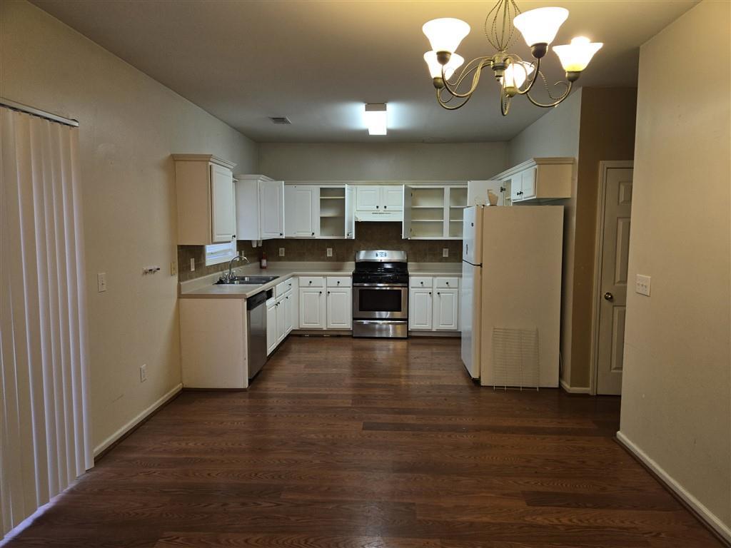 1558 Silver Ridge Drive Southwest Austell, GA 30106 - Photo 8 of 24 a kitchen with stainless steel appliances granite countertop a refrigerator a stove top oven a sink dishwasher and wooden floor